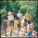 Locals join the group on a trek through the forest