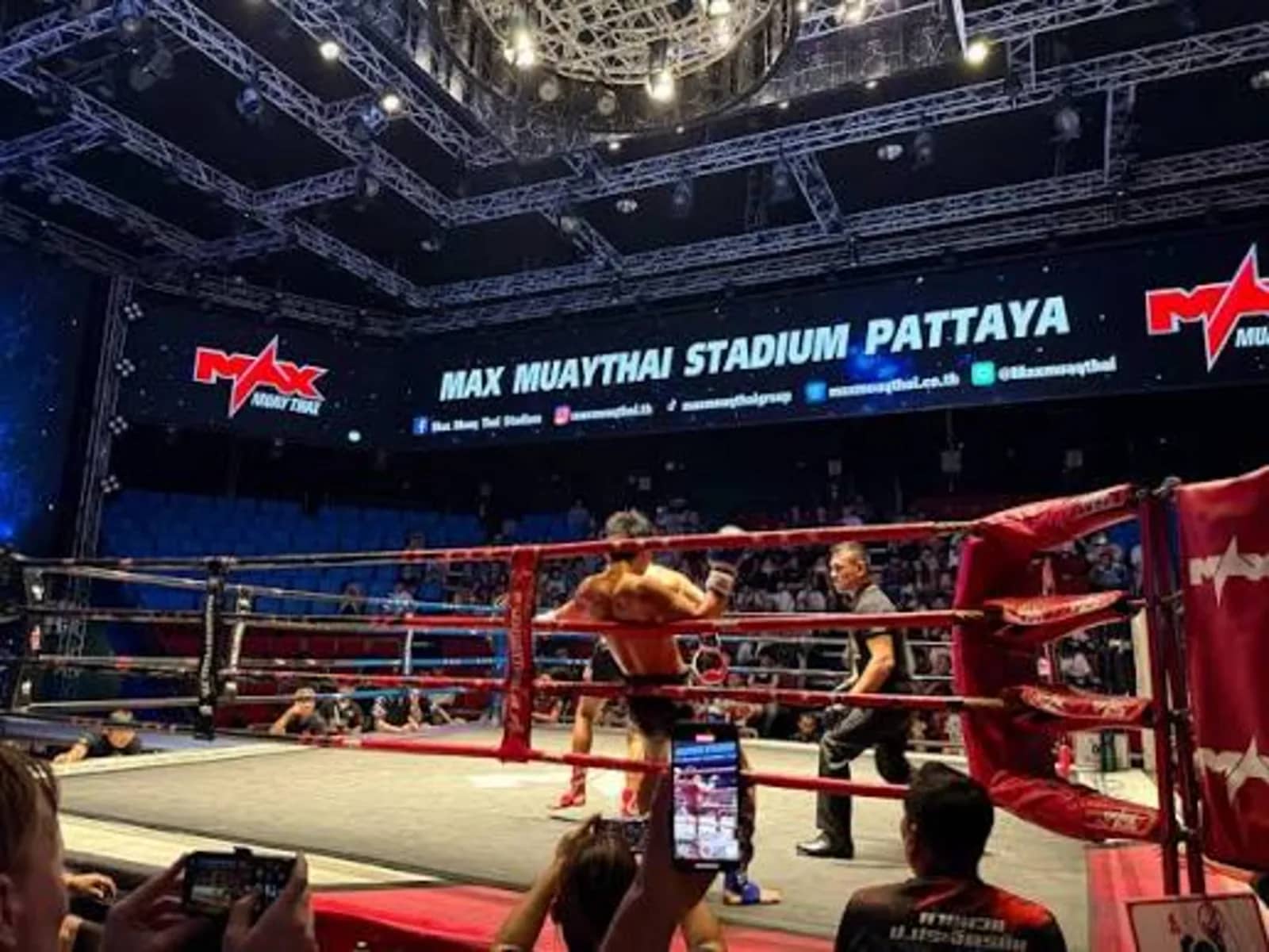 Spectators film a fight from ringside under the Max Muay Thai Stadium Pattaya banner