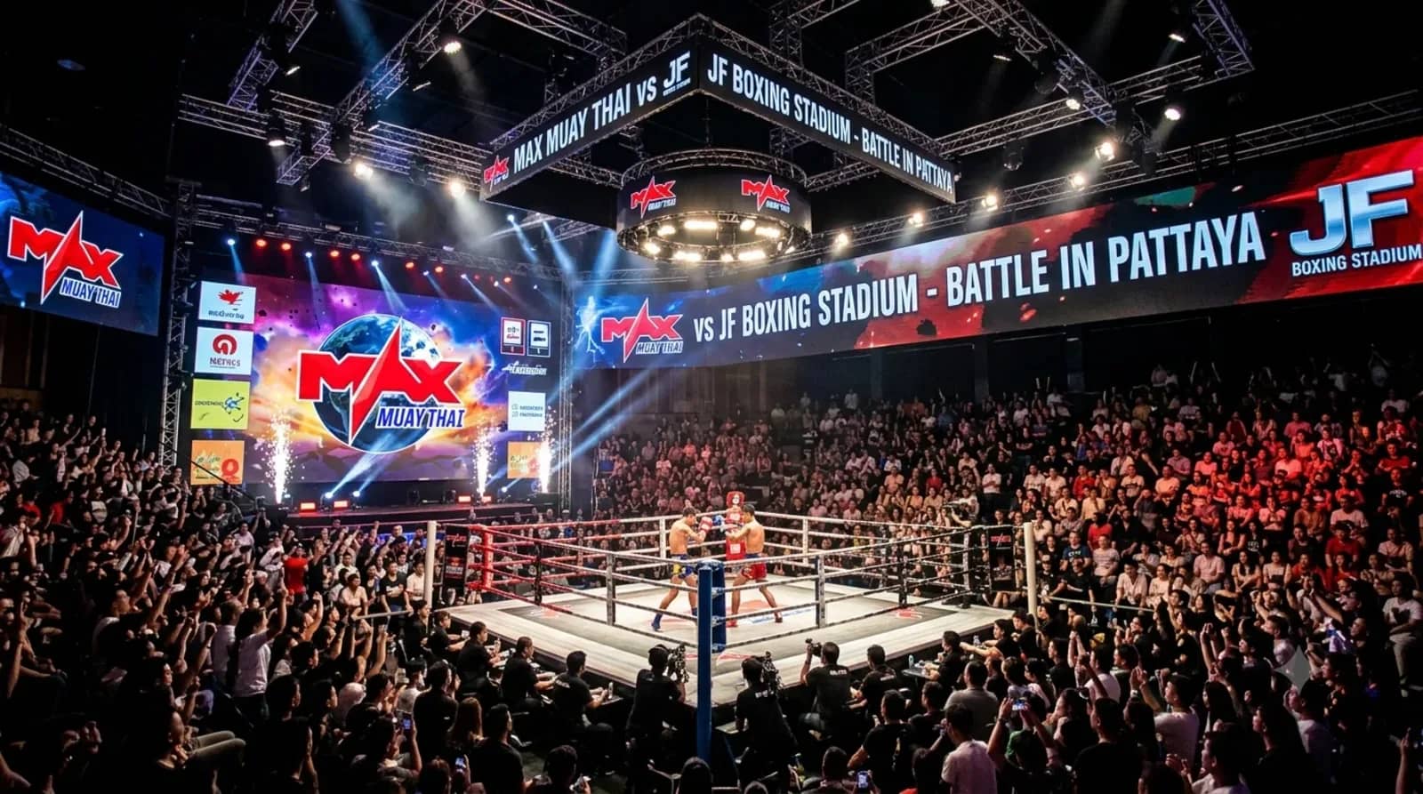 A large crowd surrounds the lit ring during a fight night at Max Muay Thai Stadium in Pattaya